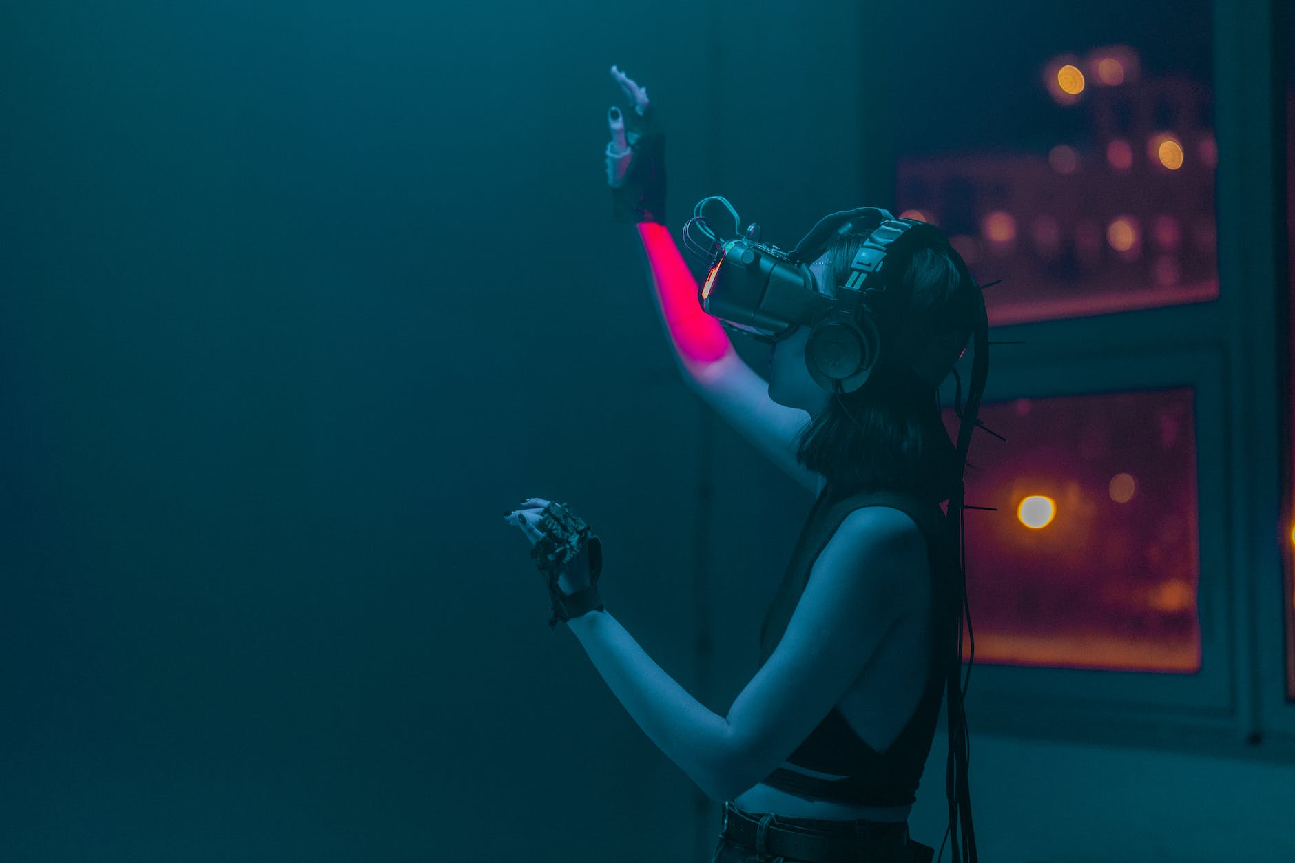 a woman in a tank top using a virtual reality headset